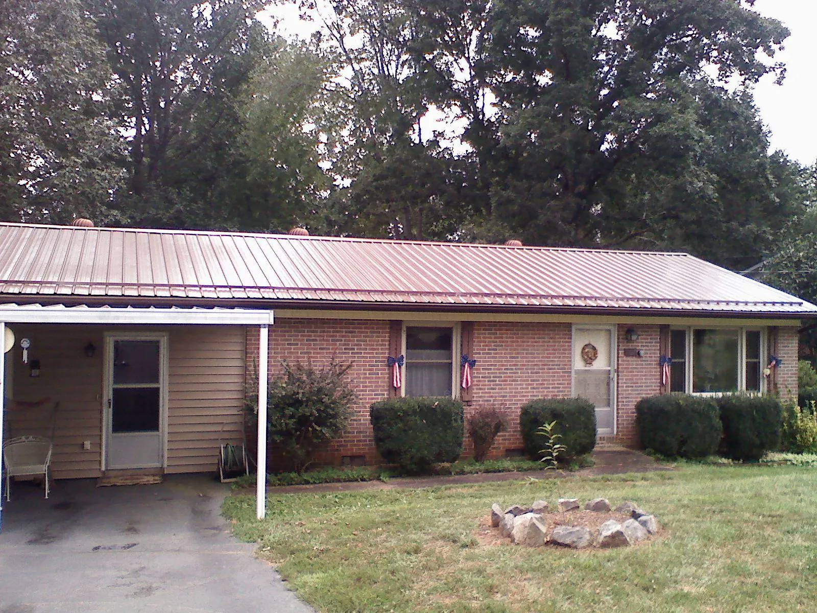 Bronze metal roof and carport on a brick ranch home — Roof Repair work by our crew in Cochranville